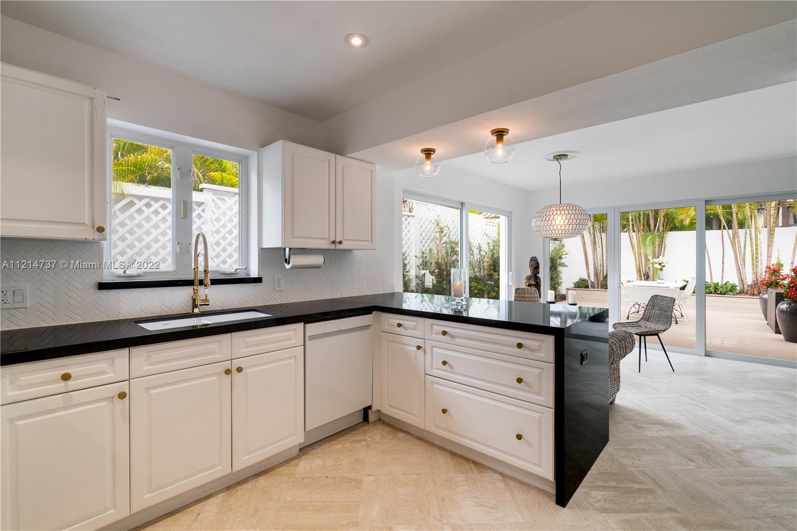 3731 Battersea Road Miami, FL 33133 - Photo 15 of 44 a kitchen with sink cabinets and window