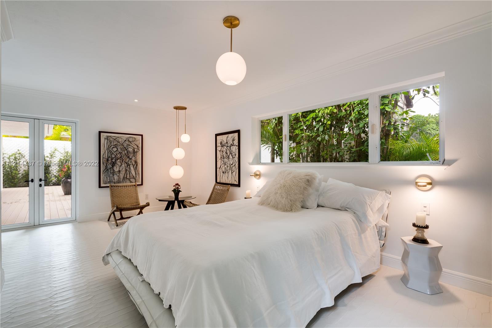 3731 Battersea Road Miami, FL 33133 - Photo 18 of 44 a bedroom with a bed and a chandelier