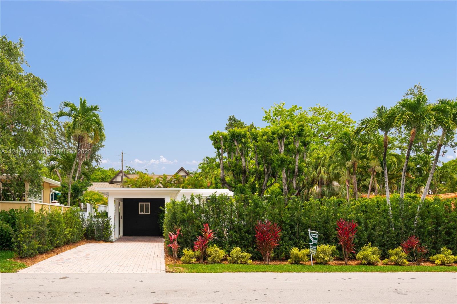 3731 Battersea Road Miami, FL 33133 - Photo 31 of 44 a view of a garden with flowers