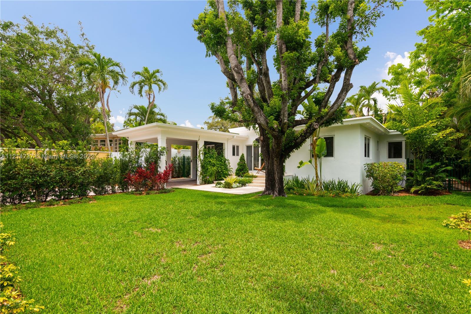 3731 Battersea Road Miami, FL 33133 - Photo 32 of 44 a view of a house with a yard