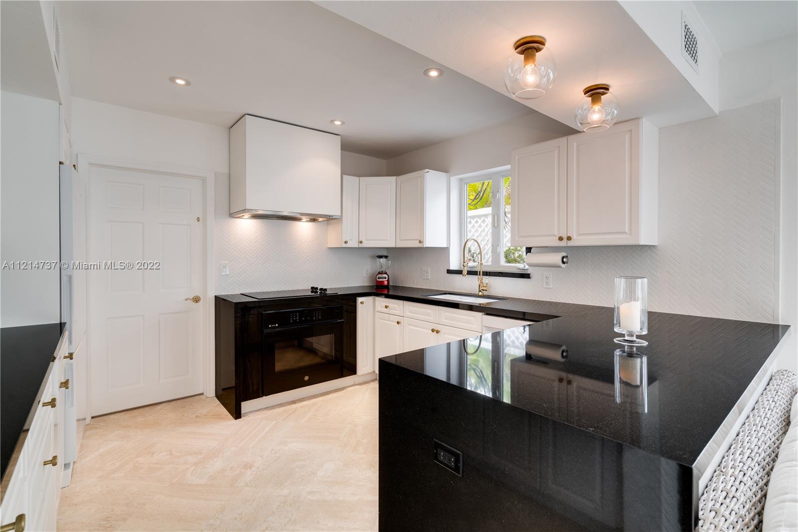 3731 Battersea Road Miami, FL 33133 - Photo 42 of 44 a kitchen with stainless steel appliances granite countertop a stove a sink and a refrigerator