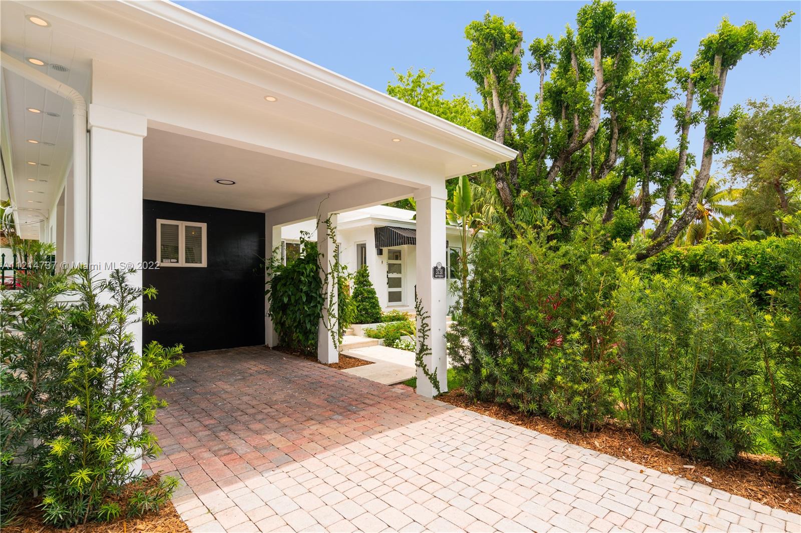 3731 Battersea Road Miami, FL 33133 - Photo 5 of 44 a view of a house with potted plants