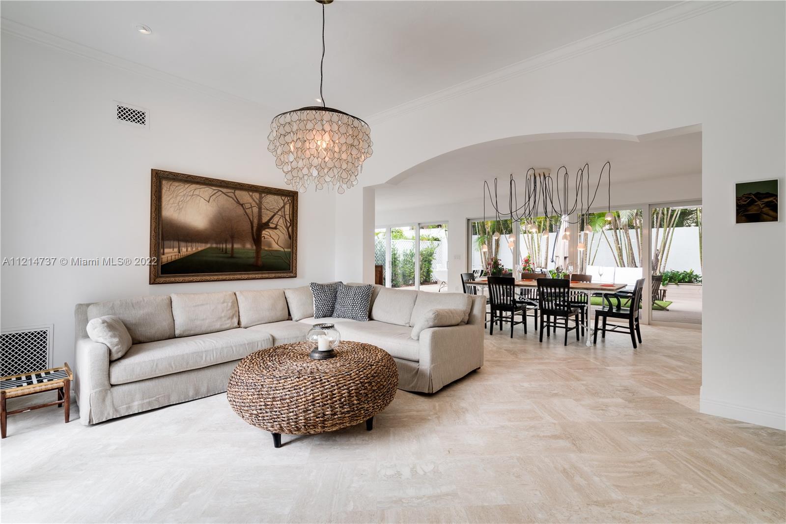 3731 Battersea Road Miami, FL 33133 - Photo 6 of 44 a living room with furniture chandelier and a large window