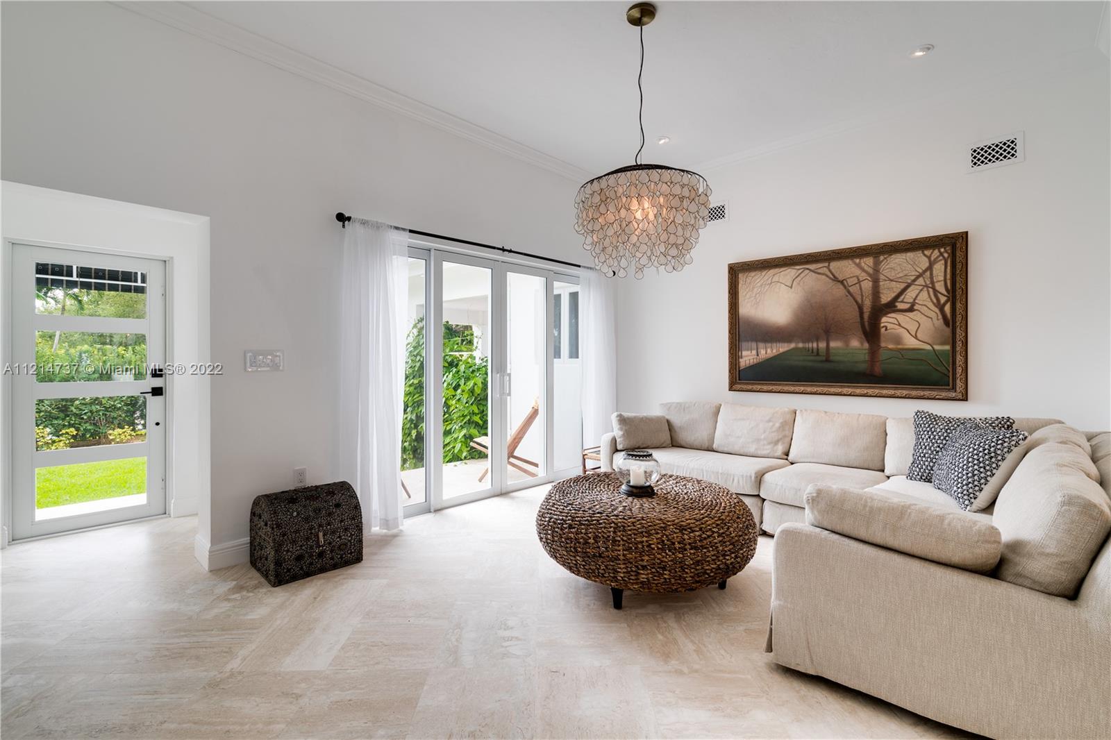 3731 Battersea Road Miami, FL 33133 - Photo 7 of 44 a living room with furniture a window and a chandelier