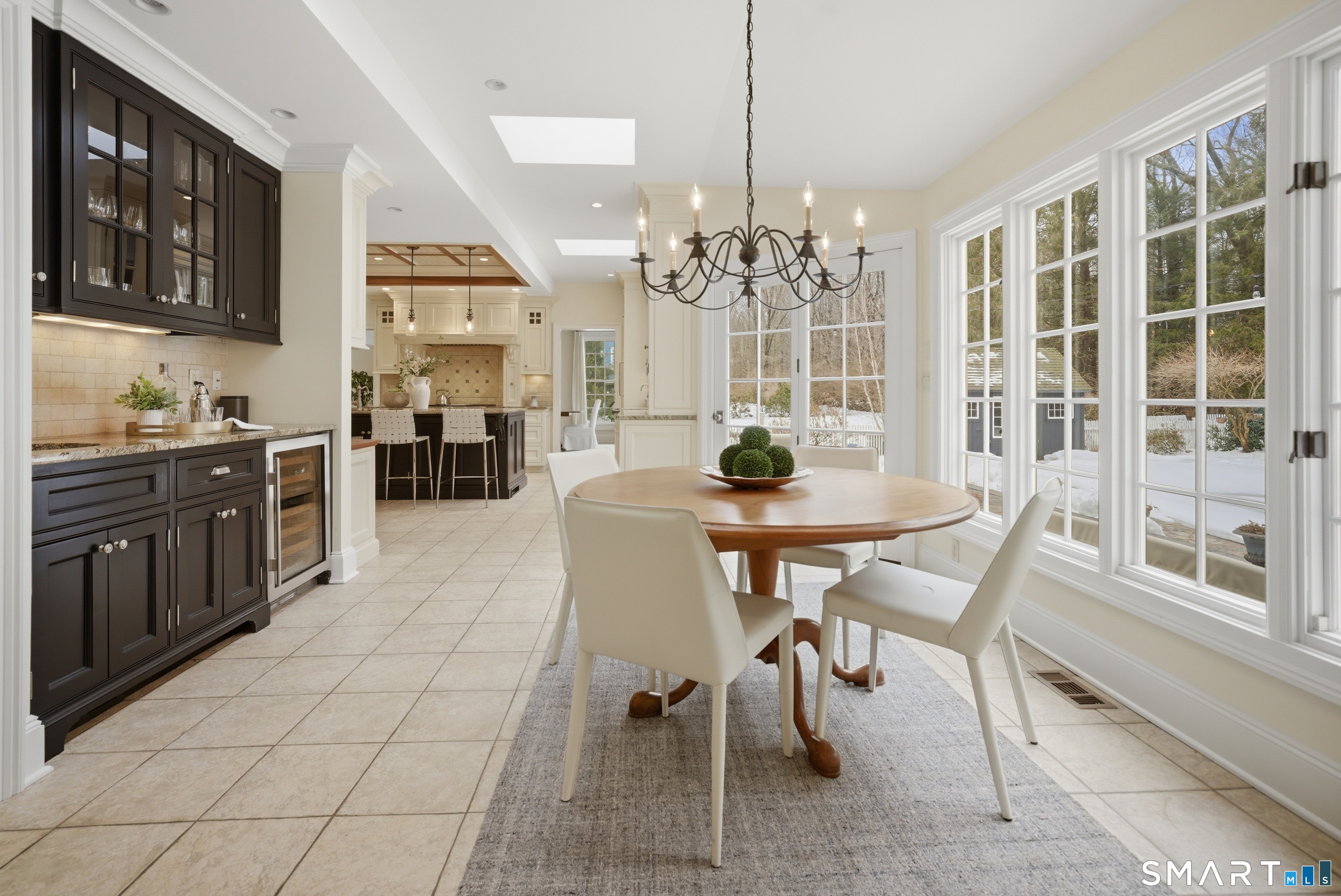 677 Eleven O'Clock Road Fairfield, CT 06824 - Photo 13 of 36 a view of a dining room with furniture and chandelier