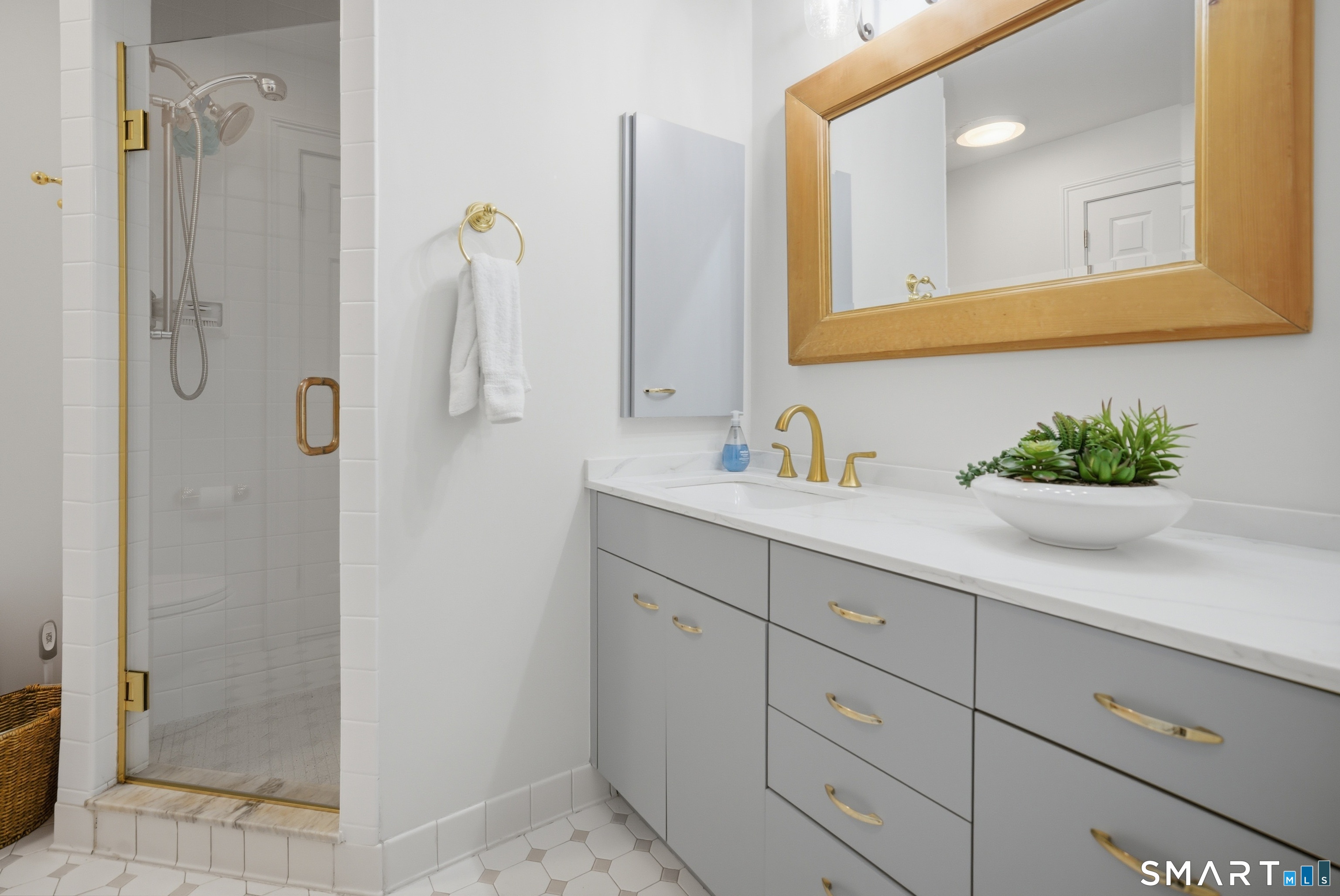 677 Eleven O'Clock Road Fairfield, CT 06824 - Photo 23 of 36 a bathroom with a shower sink vanity and mirror