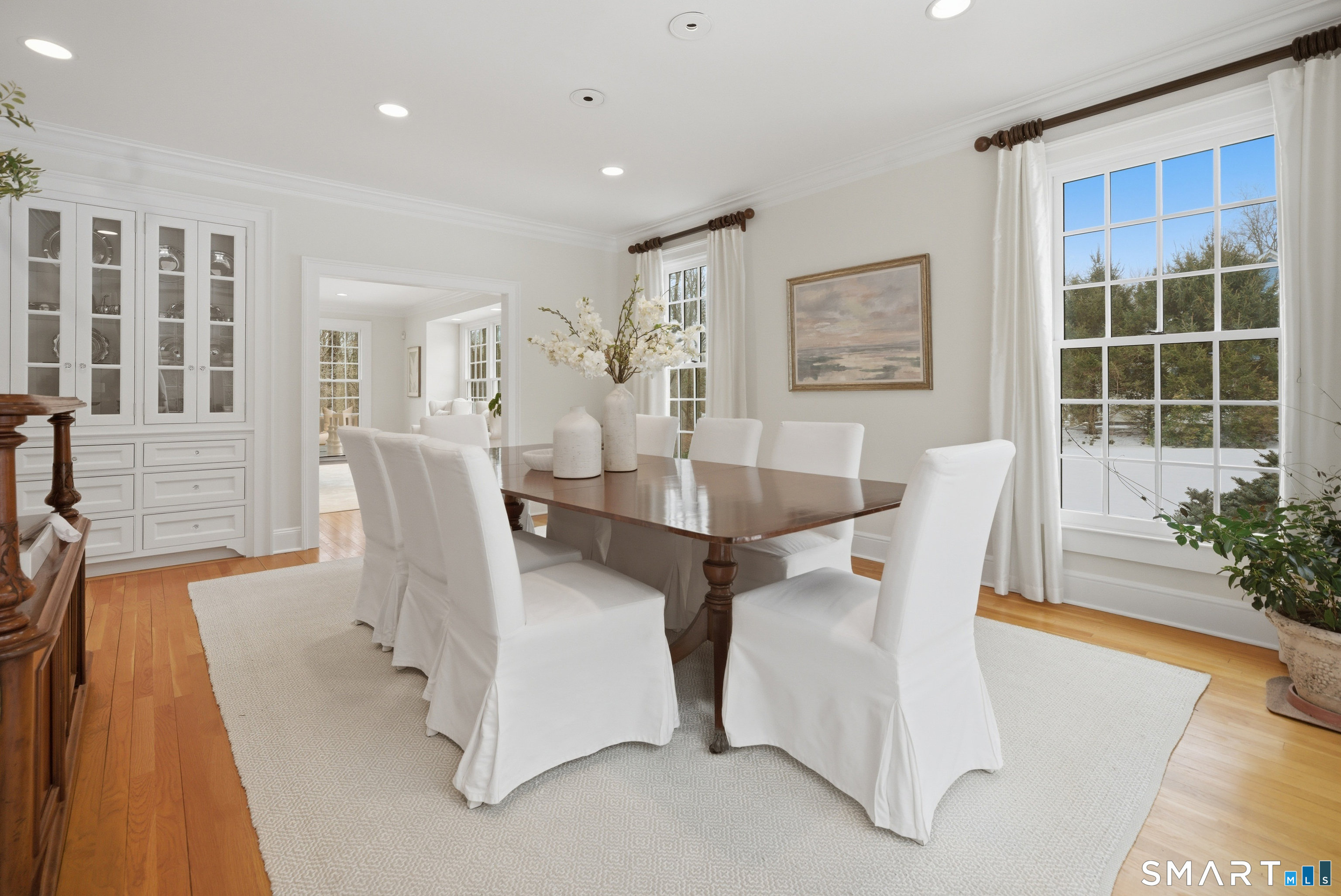 677 Eleven O'Clock Road Fairfield, CT 06824 - Photo 8 of 36 a view of a dining room with furniture and wooden floor