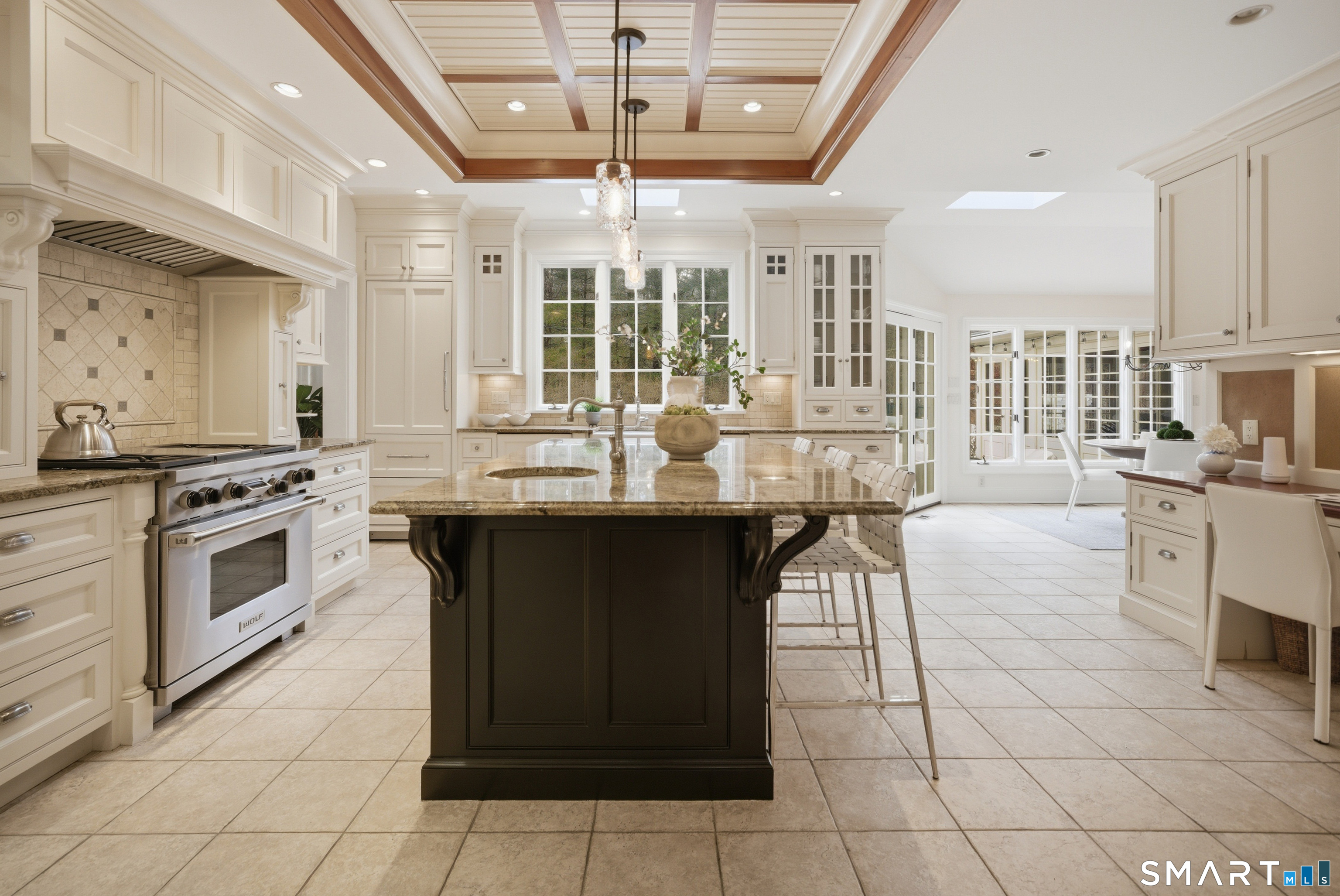677 Eleven O'Clock Road Fairfield, CT 06824 - Photo 9 of 36 a kitchen with stainless steel appliances granite countertop a stove top oven island and a refrigerator
