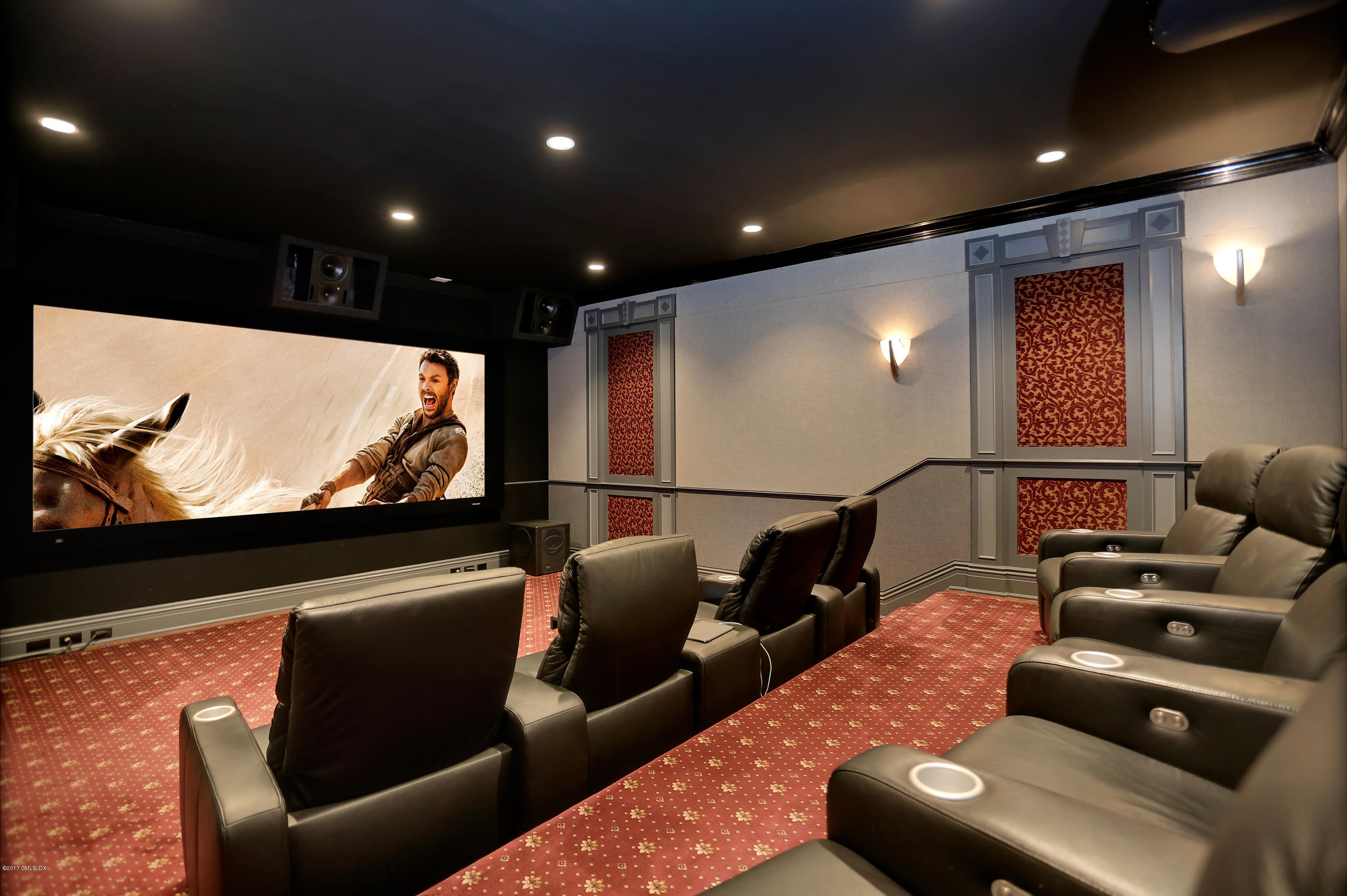 41 Leeward Lane Riverside, CT 06878 - Photo 12 of 27 a media room with lots of chairs and a projector screen