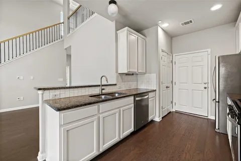 a kitchen with a sink dishwasher a refrigerator and a stove