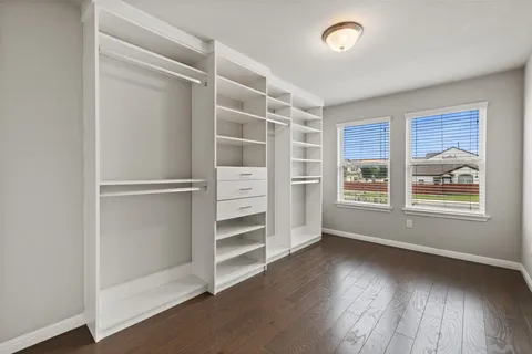 a view of wooden floor and windows in a room