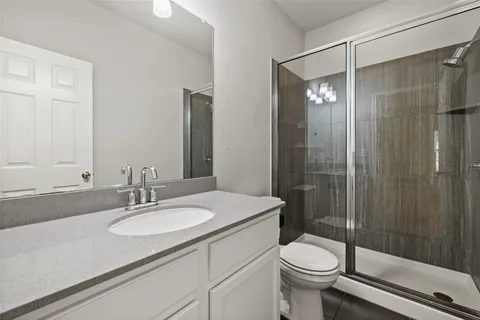 a bathroom with a sink toilet and shower