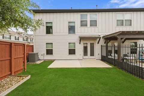 a view of a house with a yard and pathway