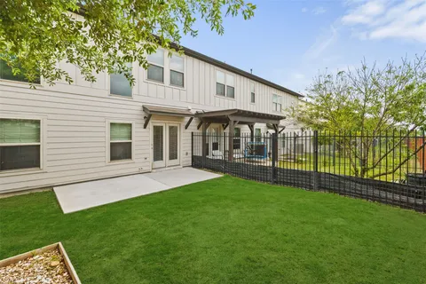 a view of a house with a yard and a garden