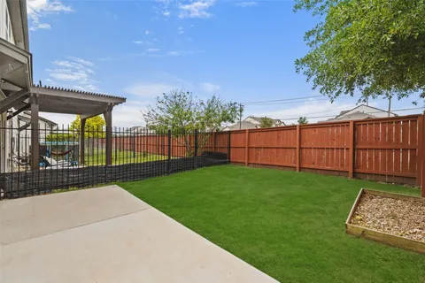 a view of a backyard with wooden fence