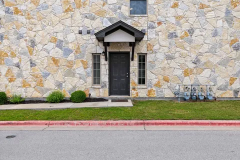 a house with a yard and a car parked in front of it