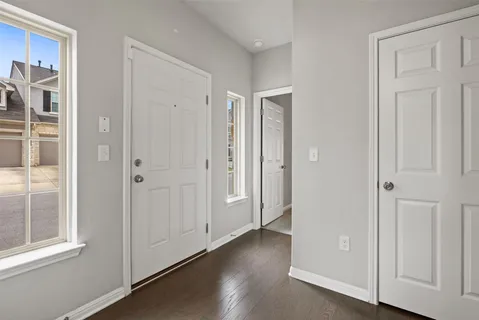 a view of a hallway with wooden floor