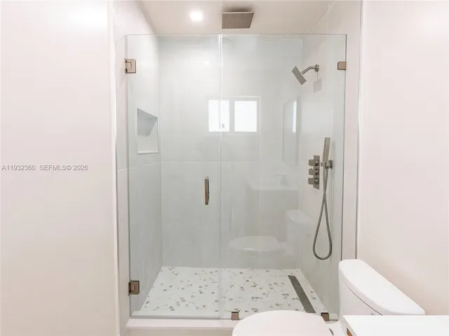 a bathroom with a shower and toilet