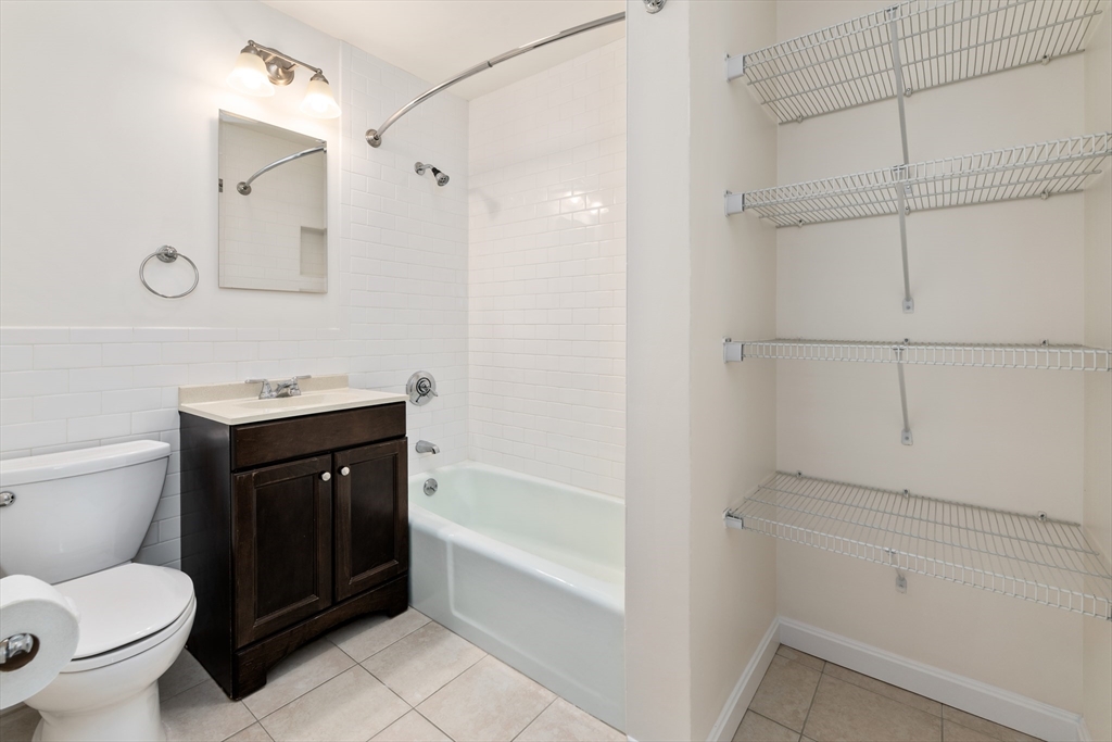 9 Buswell Street, Unit 2R Boston, MA 02215 - Photo 14 of 17 a bathroom with a toilet sink vanity and tub
