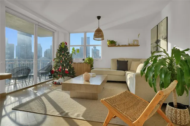 a living room with furniture and a potted plant
