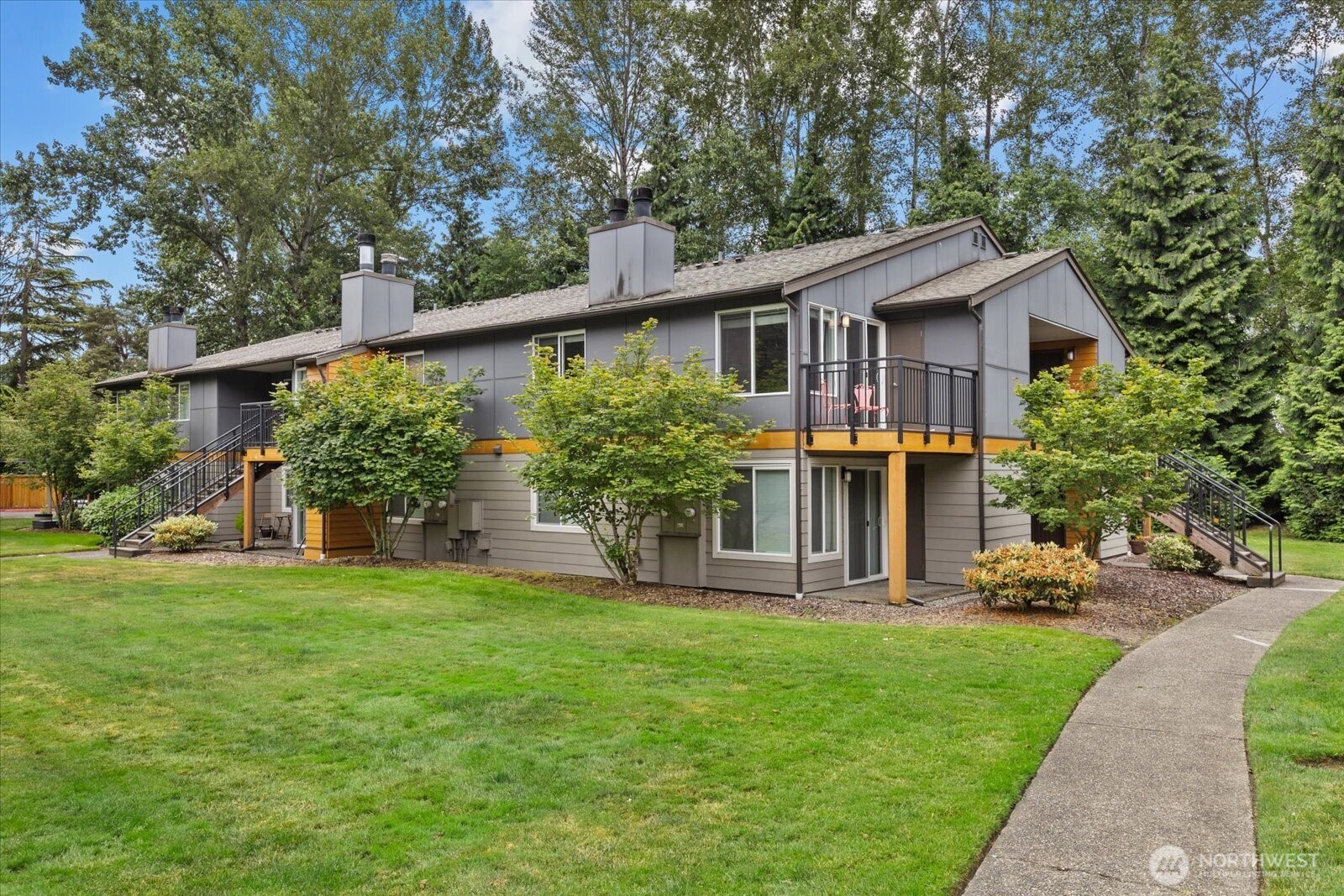 10831 Northeast 147th Lane, Unit R202 Bothell, WA 98011 - Photo 1 of 30 a front view of house with yard and green space