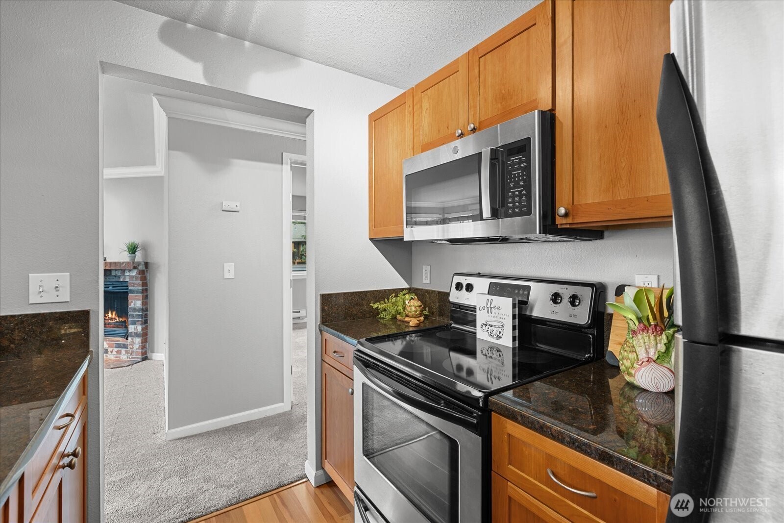 10831 Northeast 147th Lane, Unit R202 Bothell, WA 98011 - Photo 11 of 30 a kitchen with a stove and a microwave