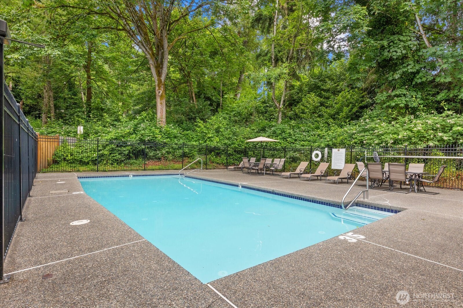 10831 Northeast 147th Lane, Unit R202 Bothell, WA 98011 - Photo 22 of 30 a swimming pool with outdoor seating and yard