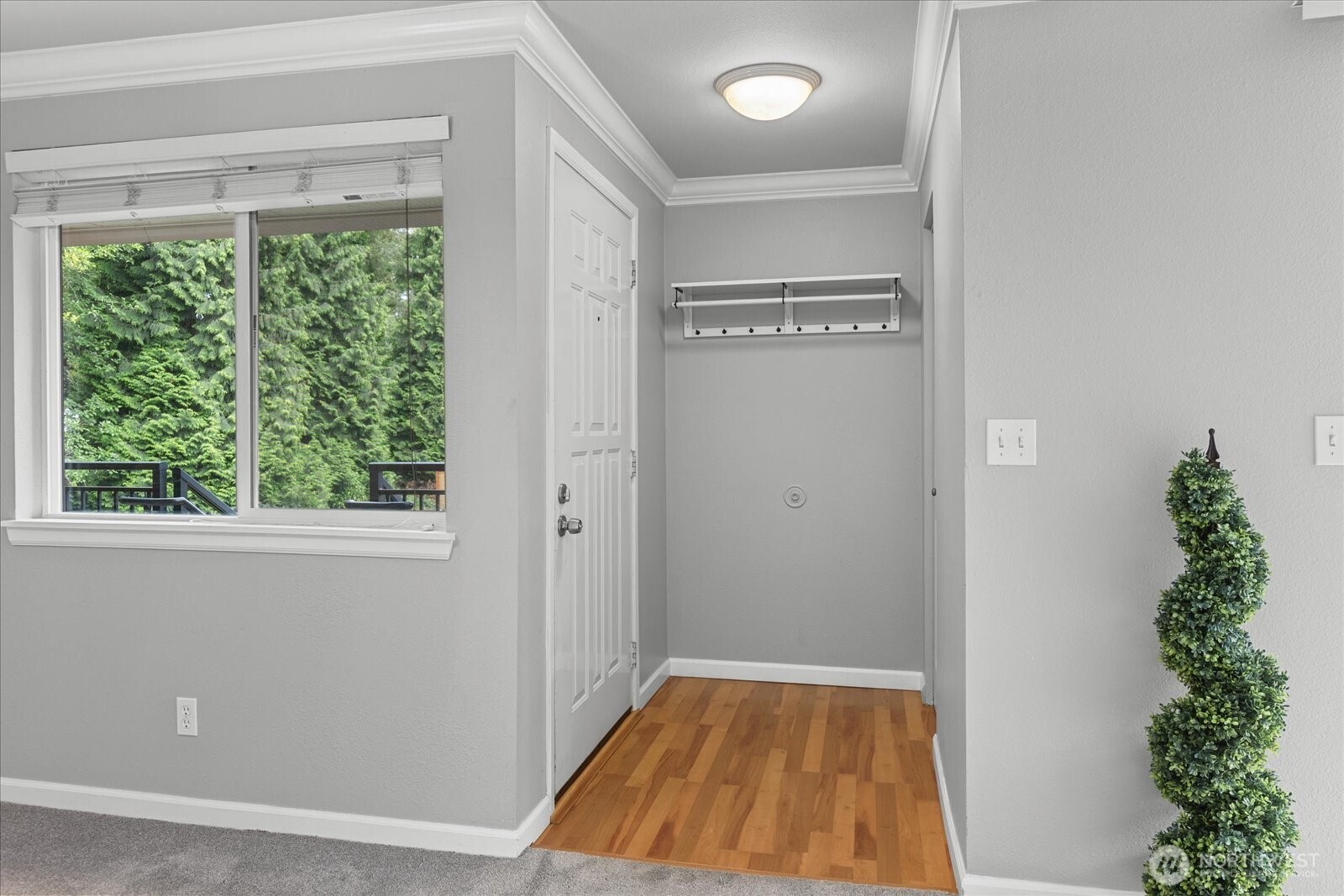 10831 Northeast 147th Lane, Unit R202 Bothell, WA 98011 - Photo 3 of 30 a view of empty room with window and wooden floor