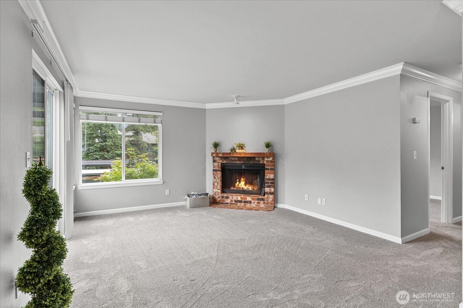 10831 Northeast 147th Lane, Unit R202 Bothell, WA 98011 - Photo 4 of 30 a view of an empty room with a window and fireplace