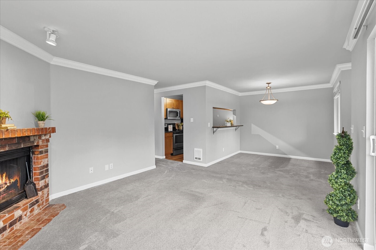 10831 Northeast 147th Lane, Unit R202 Bothell, WA 98011 - Photo 6 of 30 an empty room with a fireplace and plants