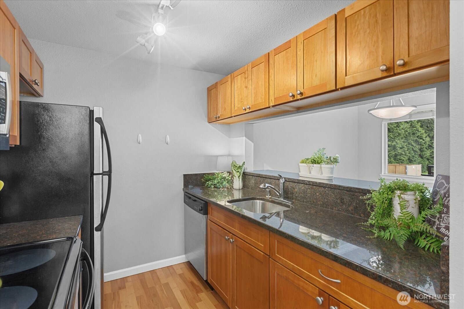 10831 Northeast 147th Lane, Unit R202 Bothell, WA 98011 - Photo 8 of 30 a kitchen with stainless steel appliances granite countertop a refrigerator and a sink