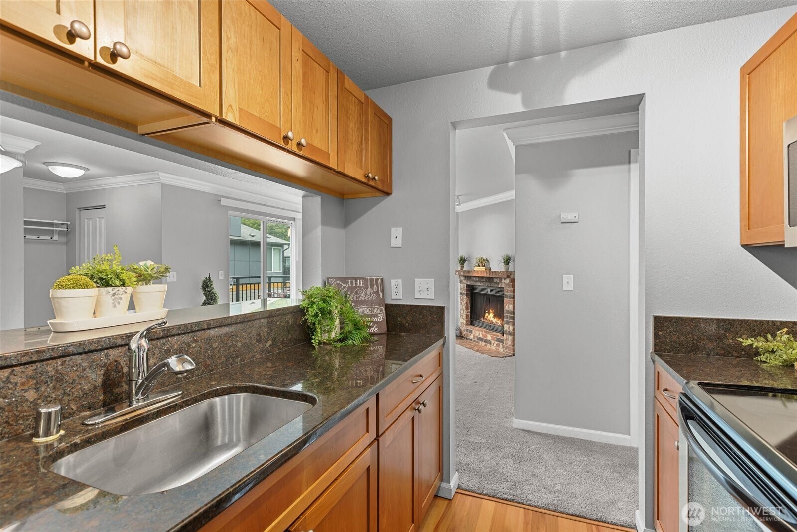 10831 Northeast 147th Lane, Unit R202 Bothell, WA 98011 - Photo 10 of 30 a kitchen with stainless steel appliances granite countertop a sink and a granite counter tops