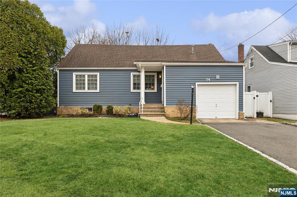 74 Spring Avenue Bergenfield, NJ 07621 - Photo 1 of 39 a house that is sitting in the grass