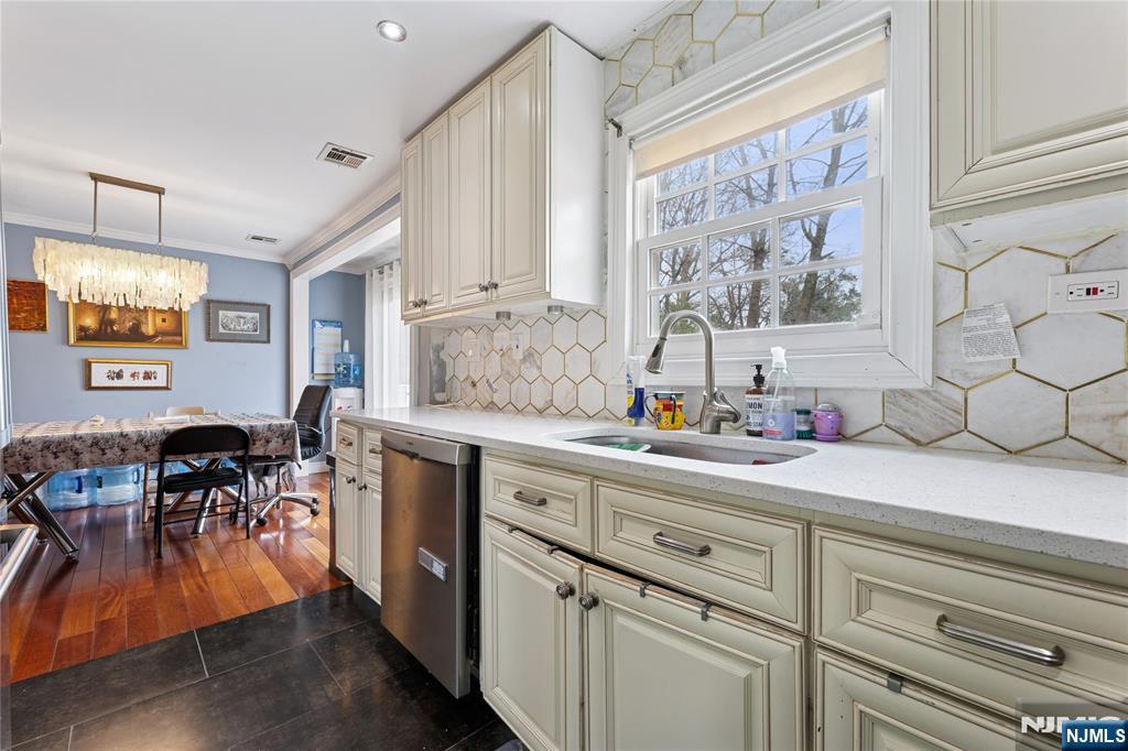 74 Spring Avenue Bergenfield, NJ 07621 - Photo 14 of 39 a kitchen with white cabinets and sink