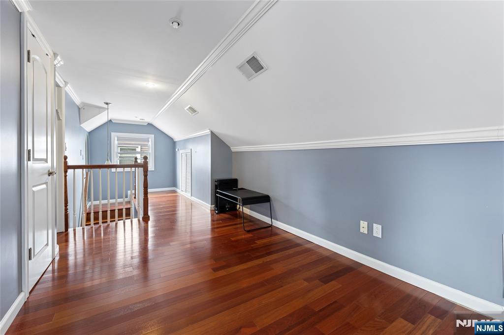 74 Spring Avenue Bergenfield, NJ 07621 - Photo 17 of 39 a hallway with wooden floor table and chairs
