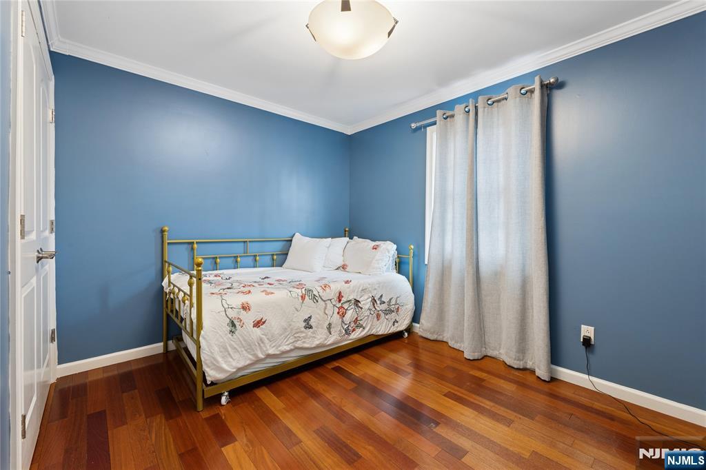 74 Spring Avenue Bergenfield, NJ 07621 - Photo 19 of 39 a bedroom with a bed and wooden floor