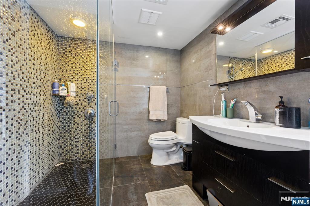 74 Spring Avenue Bergenfield, NJ 07621 - Photo 20 of 39 a bathroom with a sink toilet and shower
