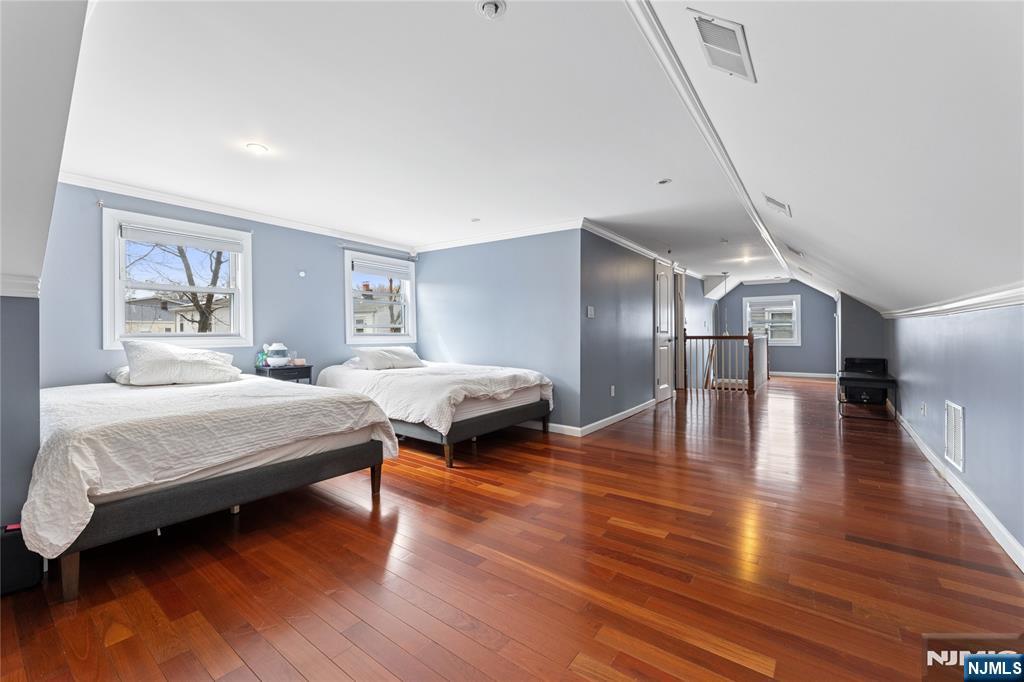 74 Spring Avenue Bergenfield, NJ 07621 - Photo 25 of 39 a spacious bedroom with a bed and a potted plant