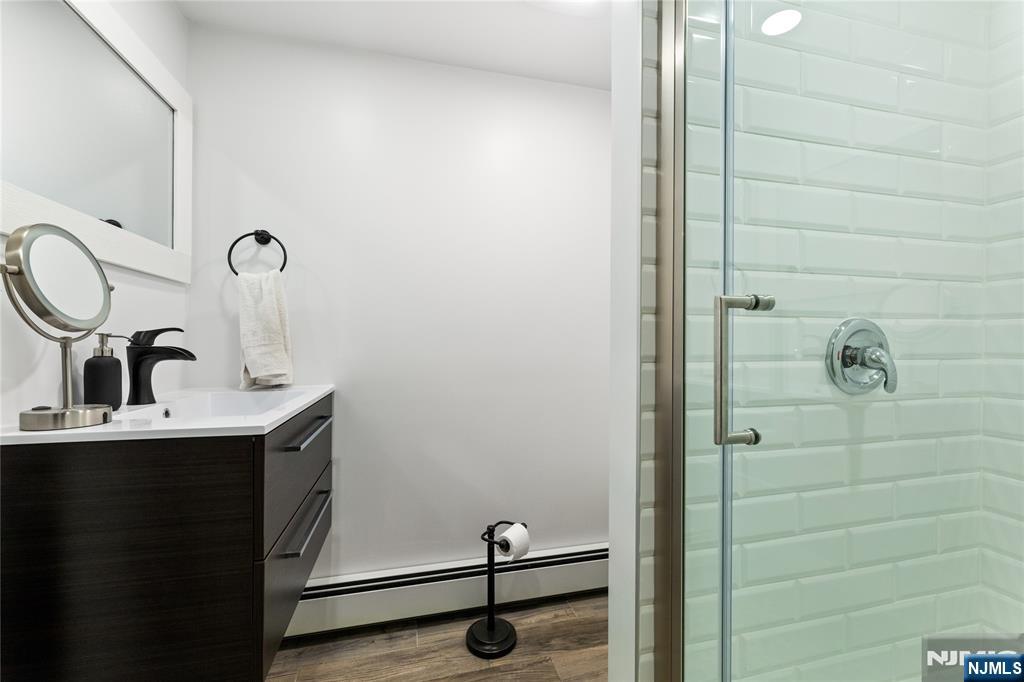 74 Spring Avenue Bergenfield, NJ 07621 - Photo 27 of 39 a bathroom with a sink and a mirror