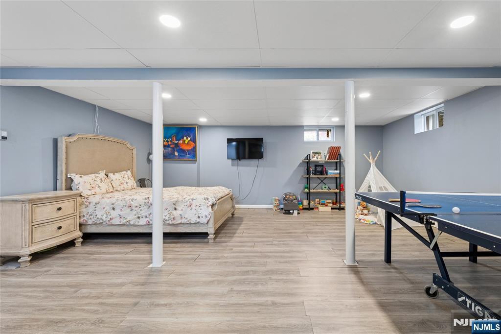 74 Spring Avenue Bergenfield, NJ 07621 - Photo 28 of 39 a bedroom with furniture and wooden floor