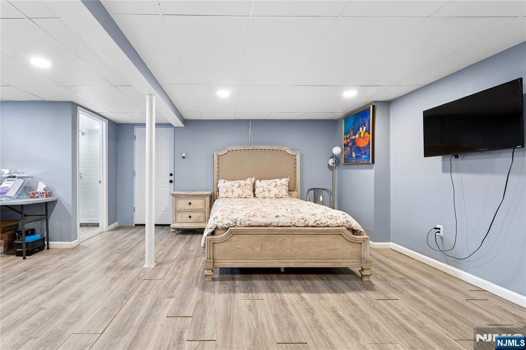 74 Spring Avenue Bergenfield, NJ 07621 - Photo 31 of 39 a bedroom with a bed and a flat screen tv