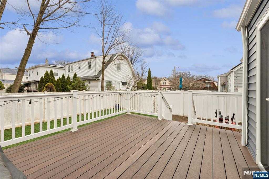 74 Spring Avenue Bergenfield, NJ 07621 - Photo 36 of 39 a view of a roof with wooden floor and fence