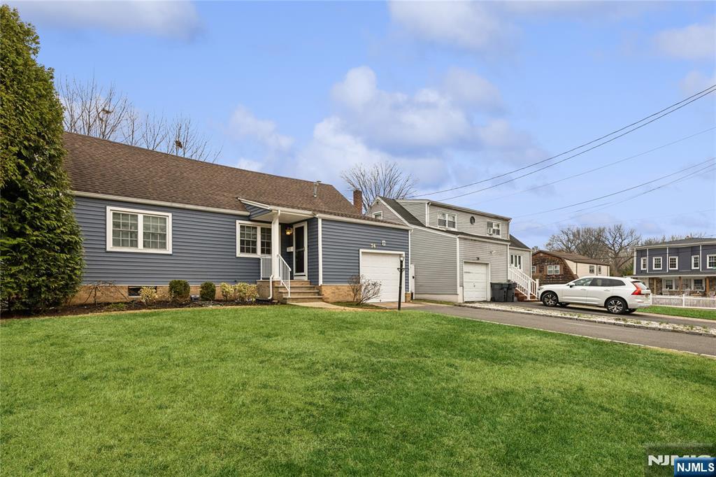 74 Spring Avenue Bergenfield, NJ 07621 - Photo 4 of 39 a house view with a sitting space and garden