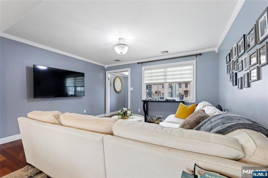 74 Spring Avenue Bergenfield, NJ 07621 - Photo 6 of 39 a living room with furniture and a flat screen tv