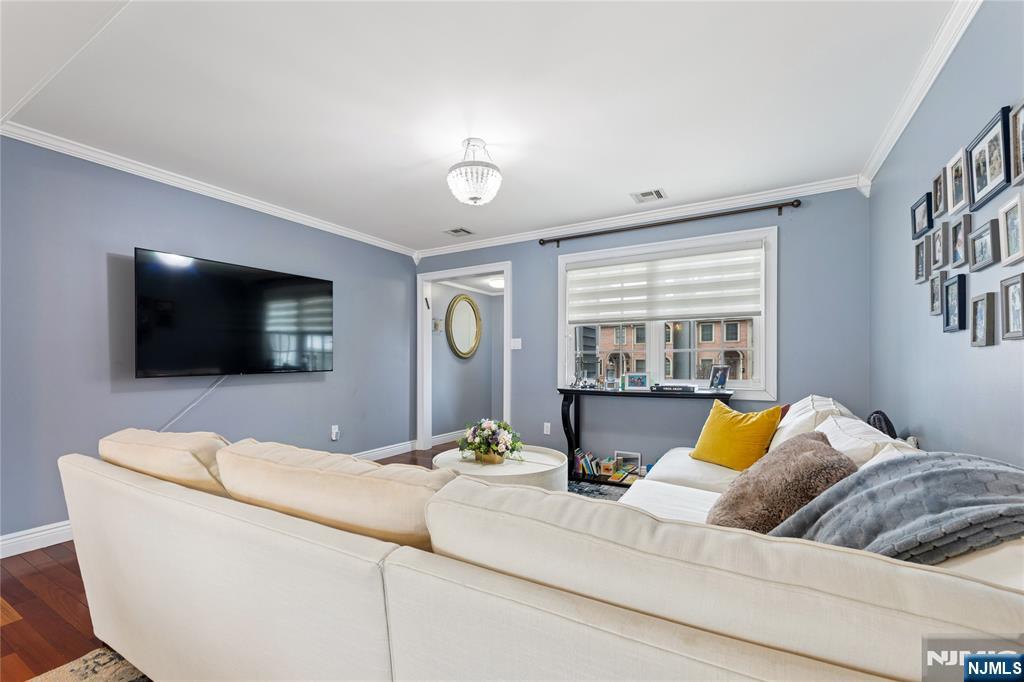 74 Spring Avenue Bergenfield, NJ 07621 - Photo 7 of 39 a living room with a couch and a flat screen tv