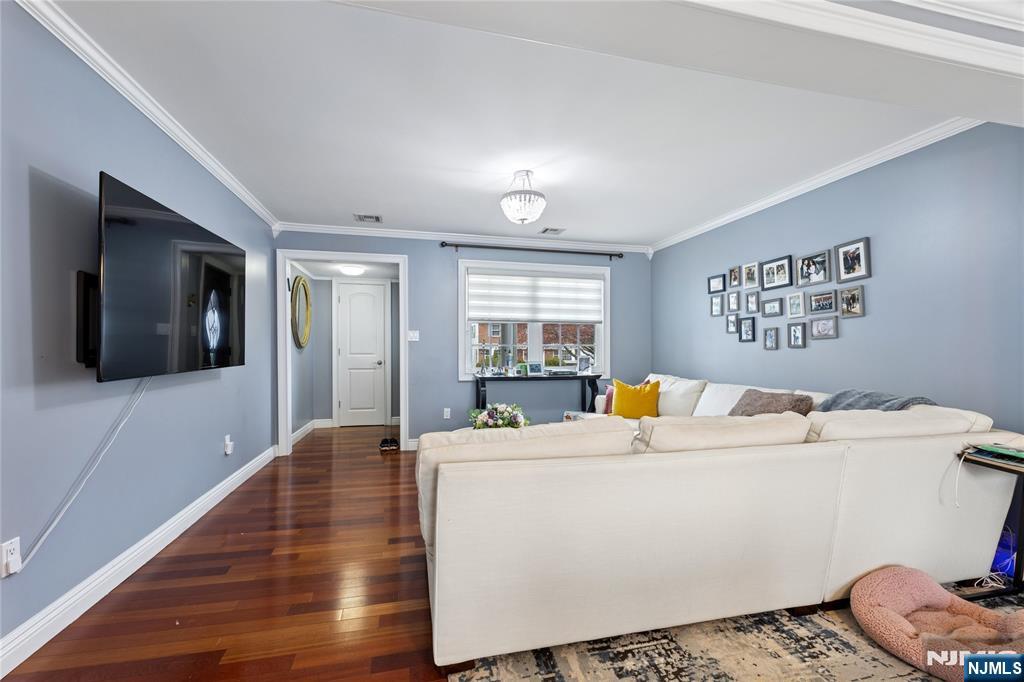 74 Spring Avenue Bergenfield, NJ 07621 - Photo 8 of 39 a living room with a couch and a flat screen tv