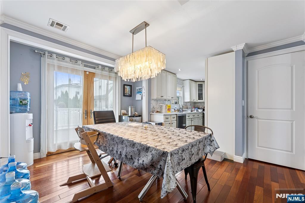 74 Spring Avenue Bergenfield, NJ 07621 - Photo 9 of 39 a view of a dining room with furniture window and wooden floor