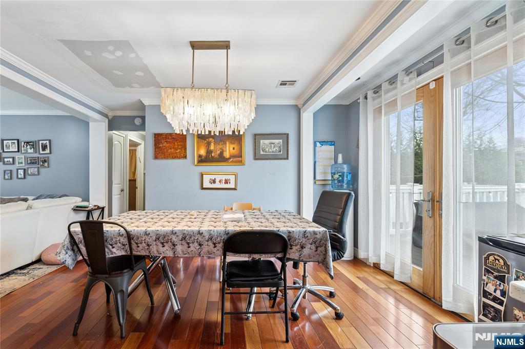 74 Spring Avenue Bergenfield, NJ 07621 - Photo 10 of 39 a view of a dining room with furniture and chandelier