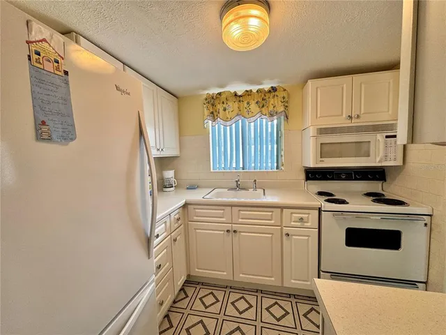 a kitchen with a sink cabinets and wooden floor