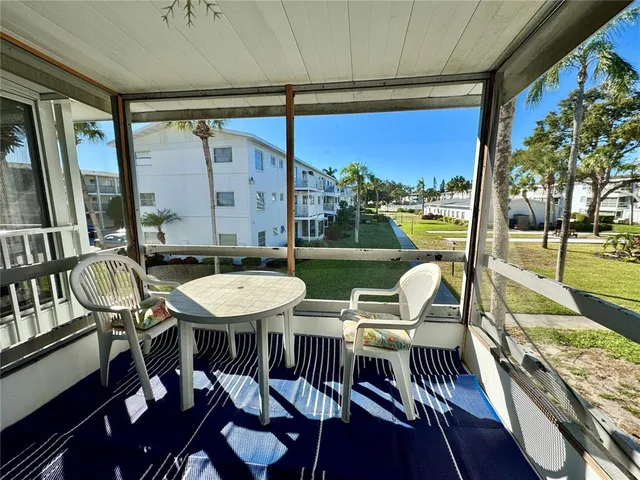 a view of a patio with table and chairs a barbeque with wooden floor and fence